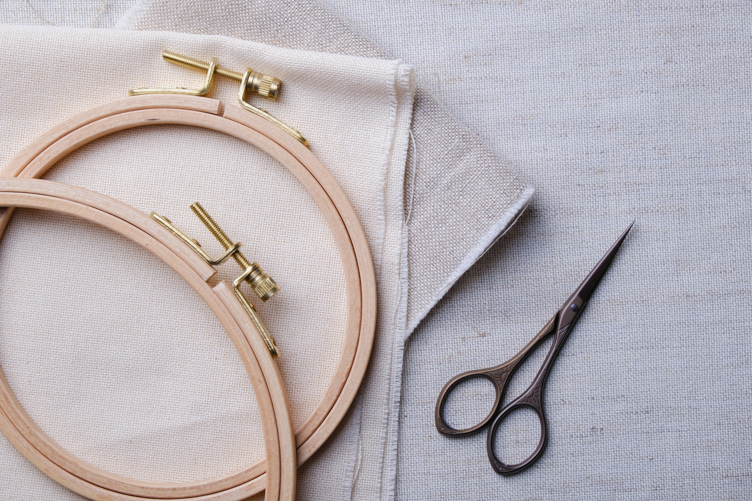 Embroidery set. White linen fabric, embroidery hoop, colorful threads and needls. Copy space